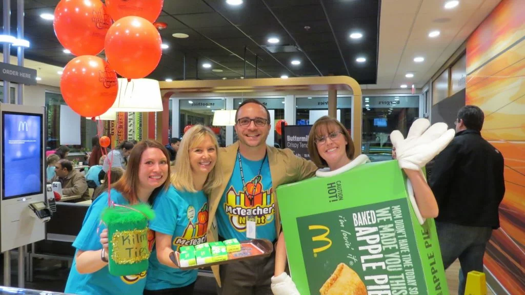 Teachers and principal serving students at McTeacher Night